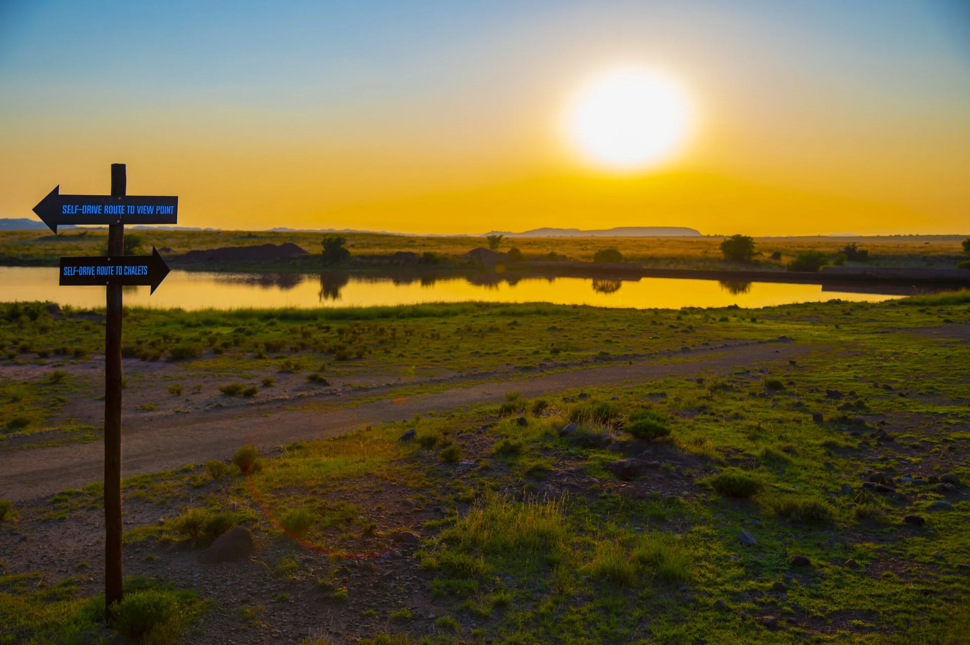 Golden sunset over water and open country at JAK Strydom